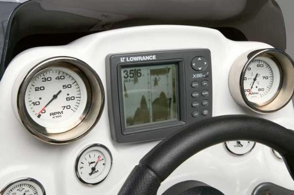 The driver's console features full instrumentation and a Lowrance fish finder. - Photo 17